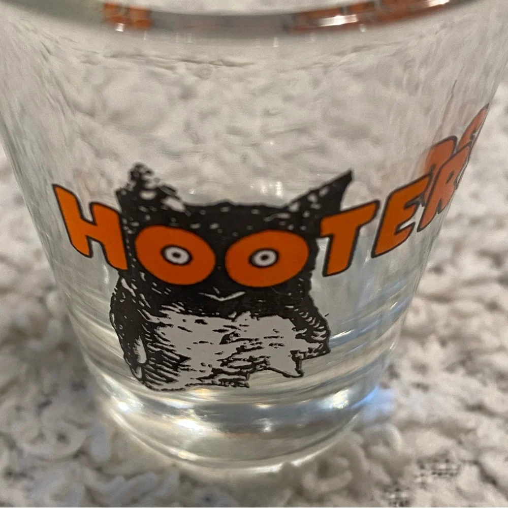 Hooter’s shot glass,  white orange with owl logo, no city specified
